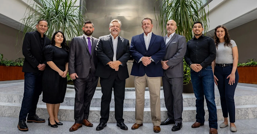 Debt Redemption Texas debt relief team standing together in a professional office