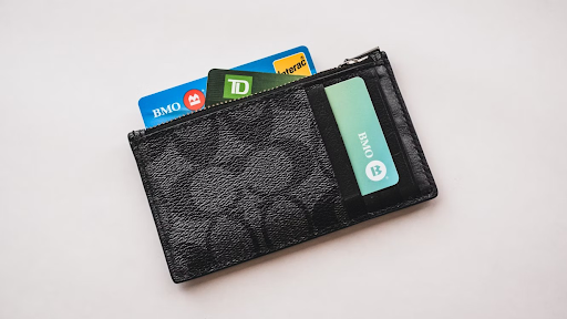 A black wallet containing multiple credit cards from different banks.
