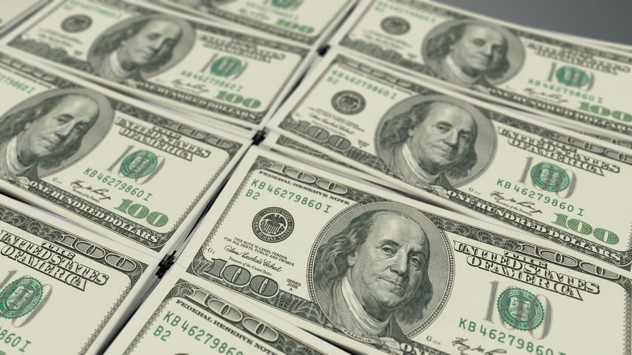Stacks of one hundred dollar bills, symbolizing financial savings through debt consolidation.