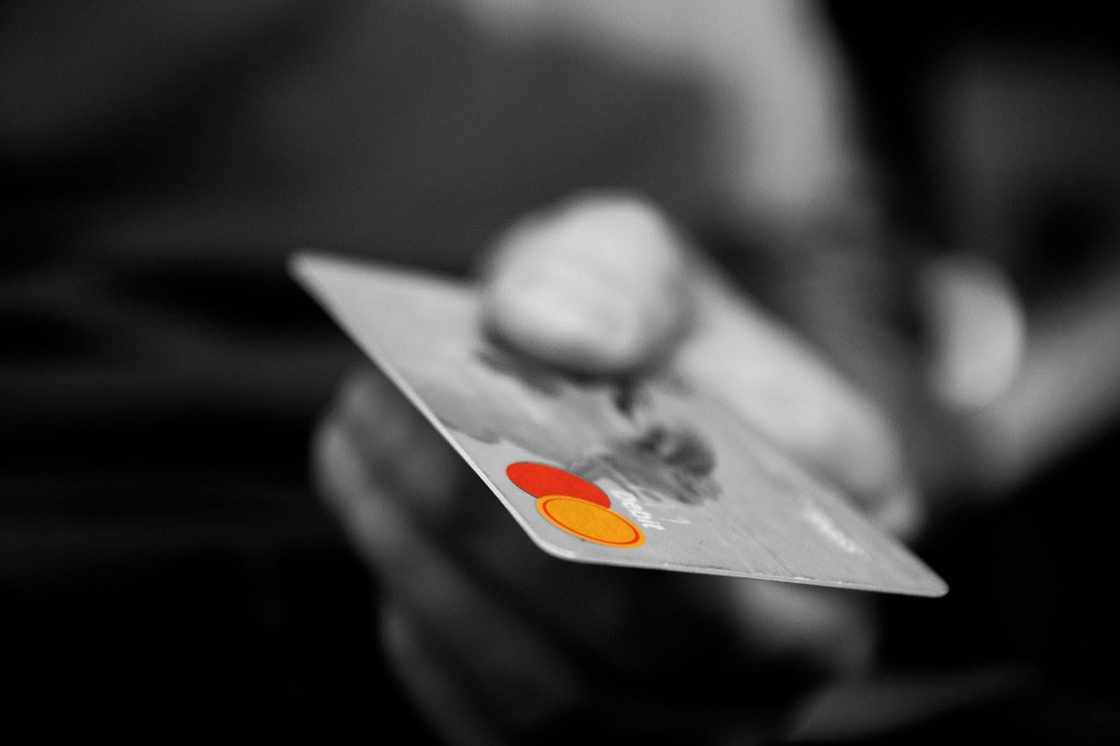 A hand holding a credit card.