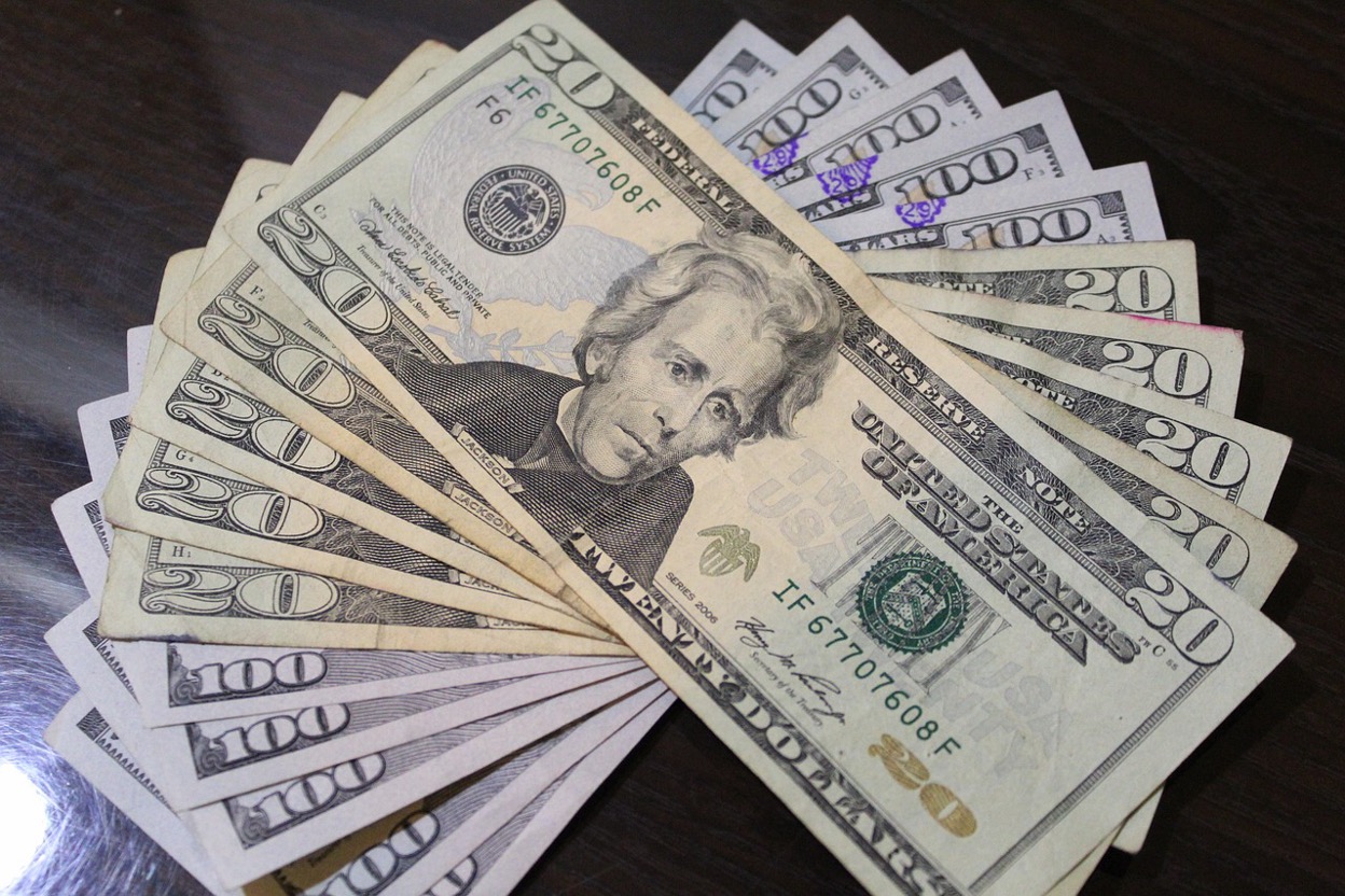 A fan of U.S. dollar bills, symbolizing financial recovery and savings