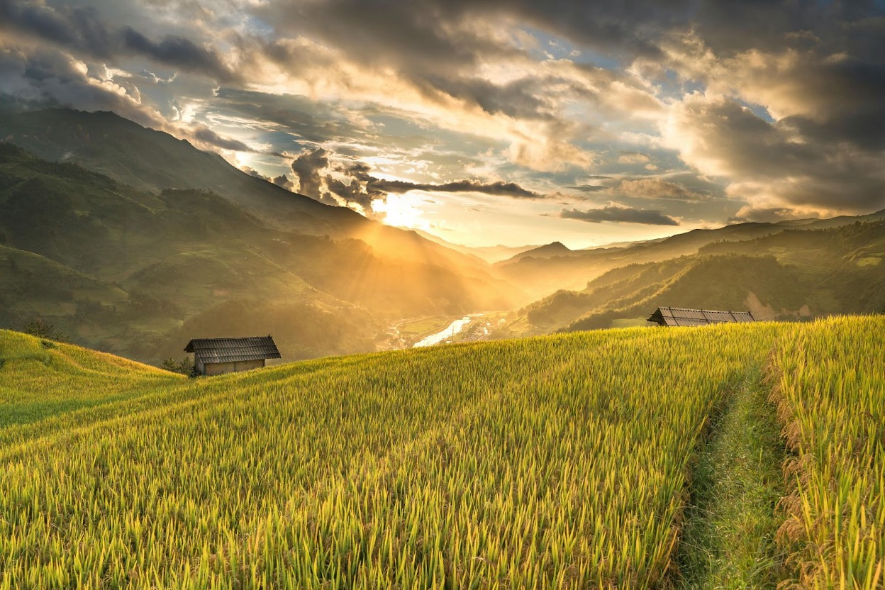 A scenic view of farmland and mountains