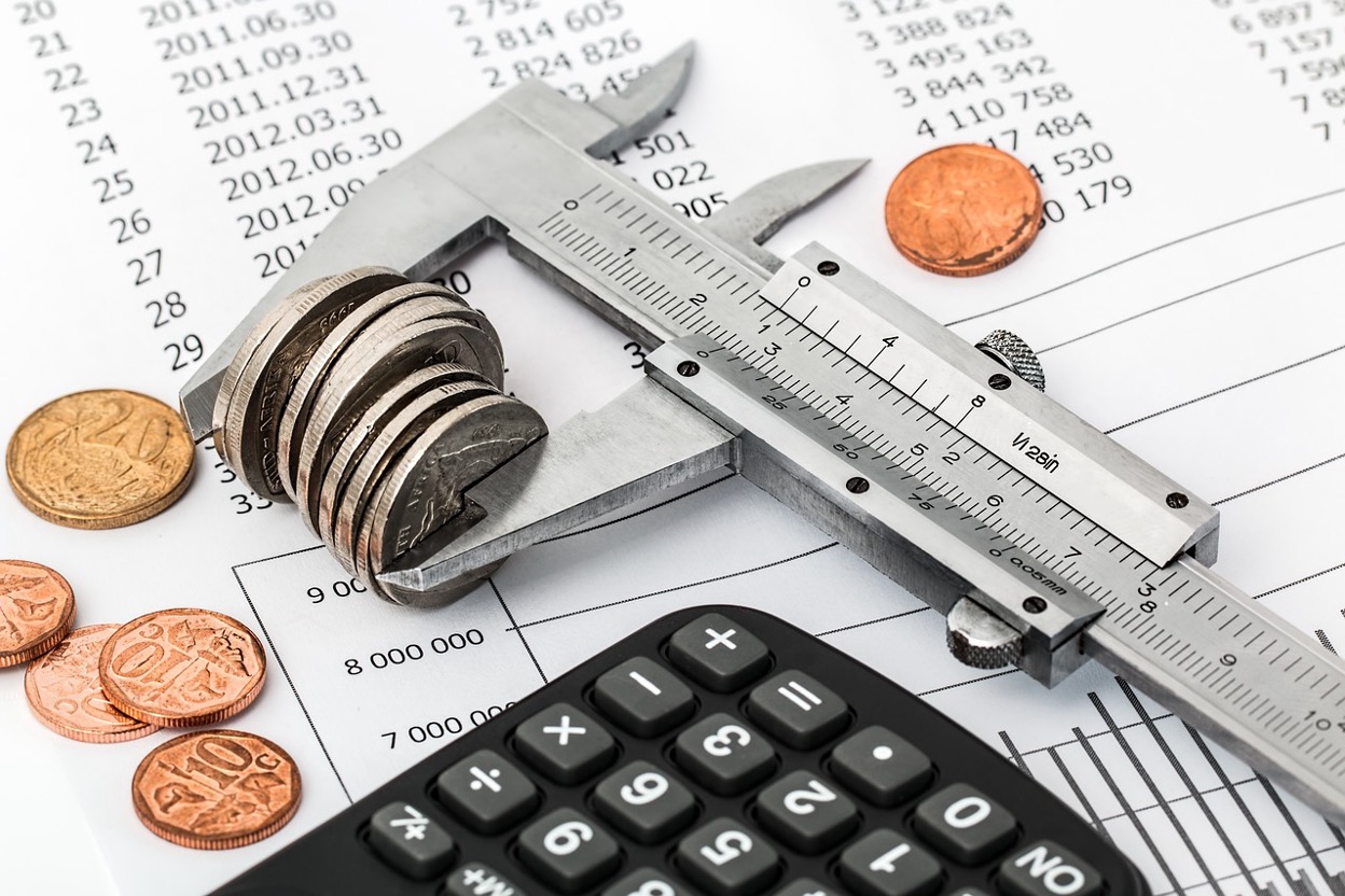 Coins being measured with a caliper
