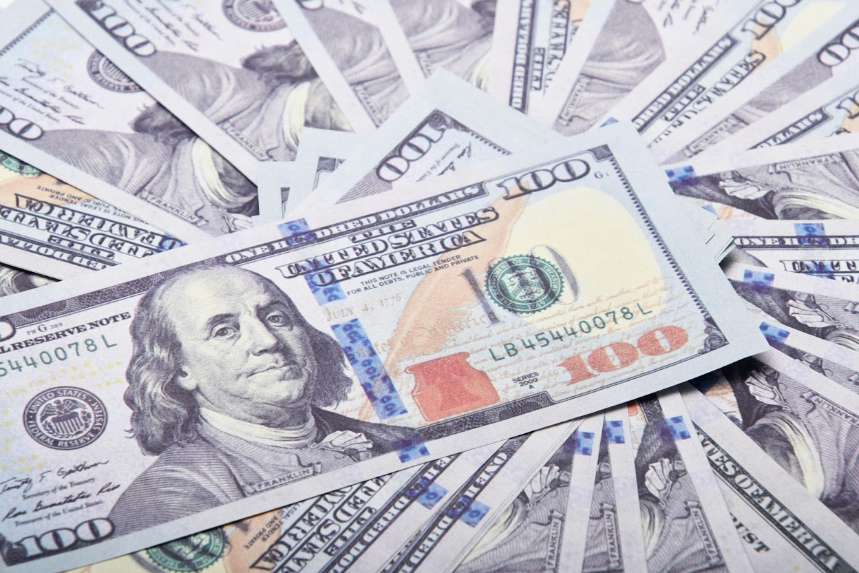 Multiple $100 bills spread out